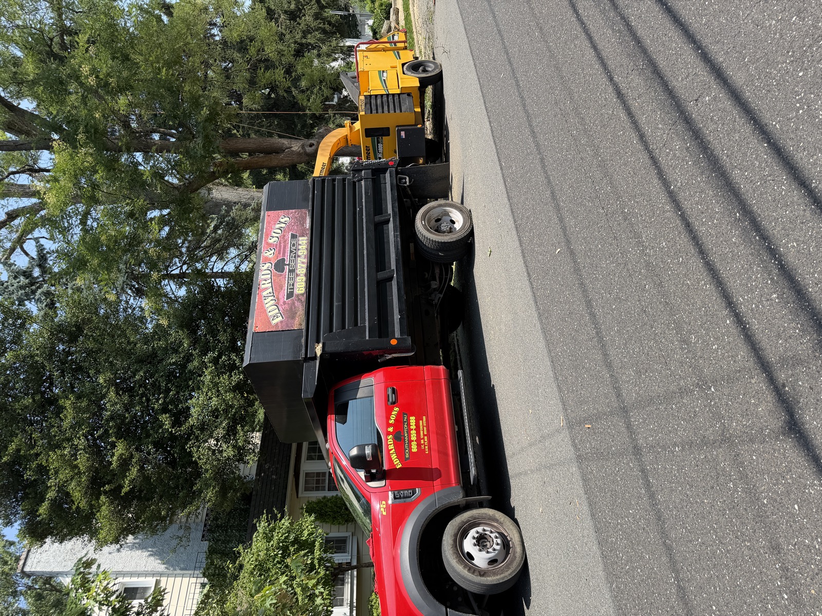 Edwards & Sons Pro chip truck and chipper on a tree job
